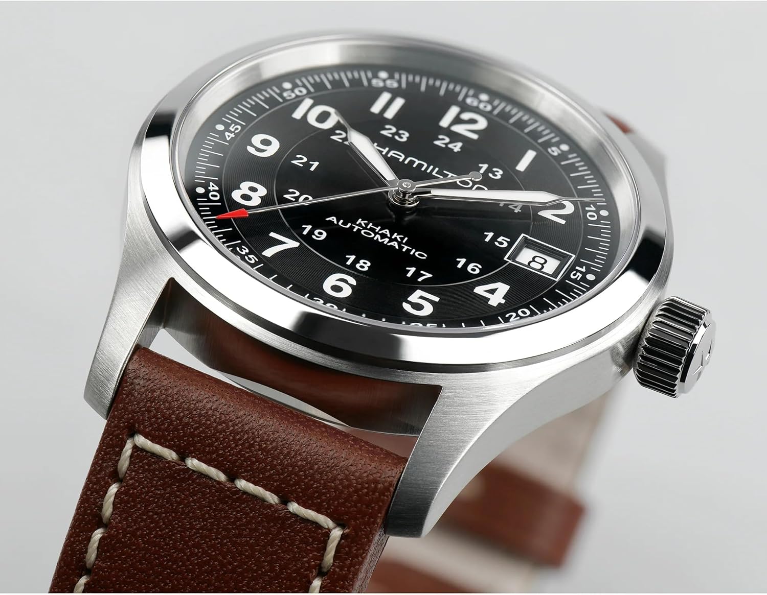 stainless steel field watch with black dial and leather strap, sapphire crystal — front
