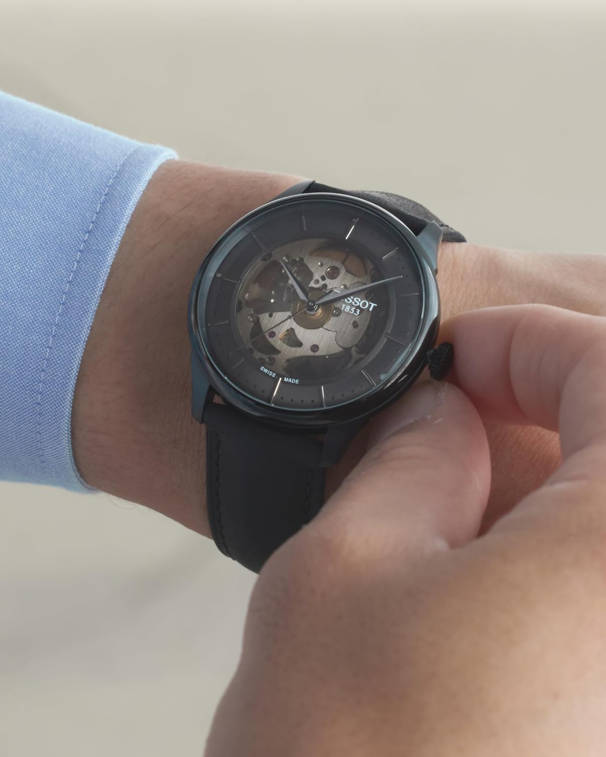 Silver stainless steel skeleton watch with transparent dial and polished case — detail