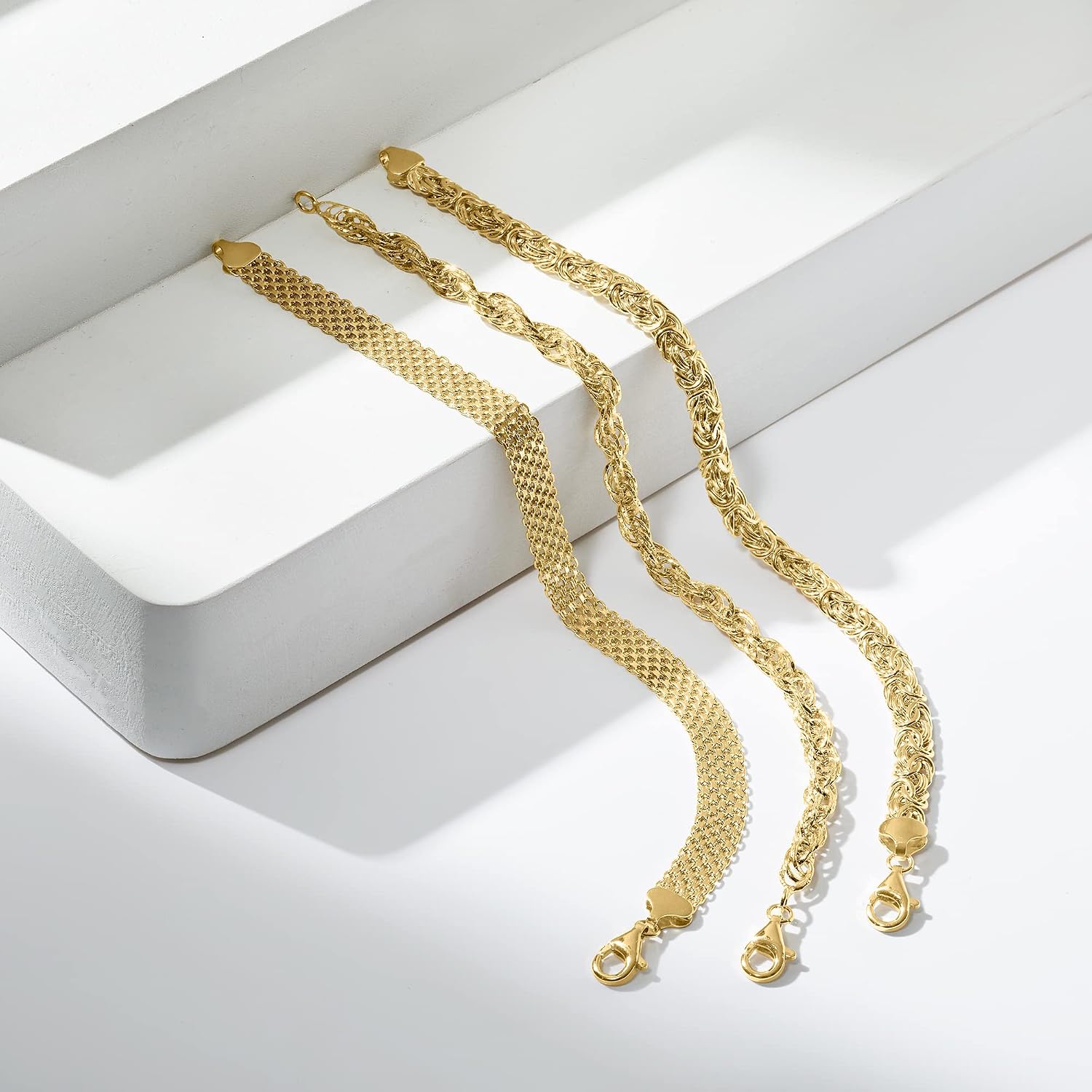 Three sterling silver link bracelets stacked together, classic polished design — view 3