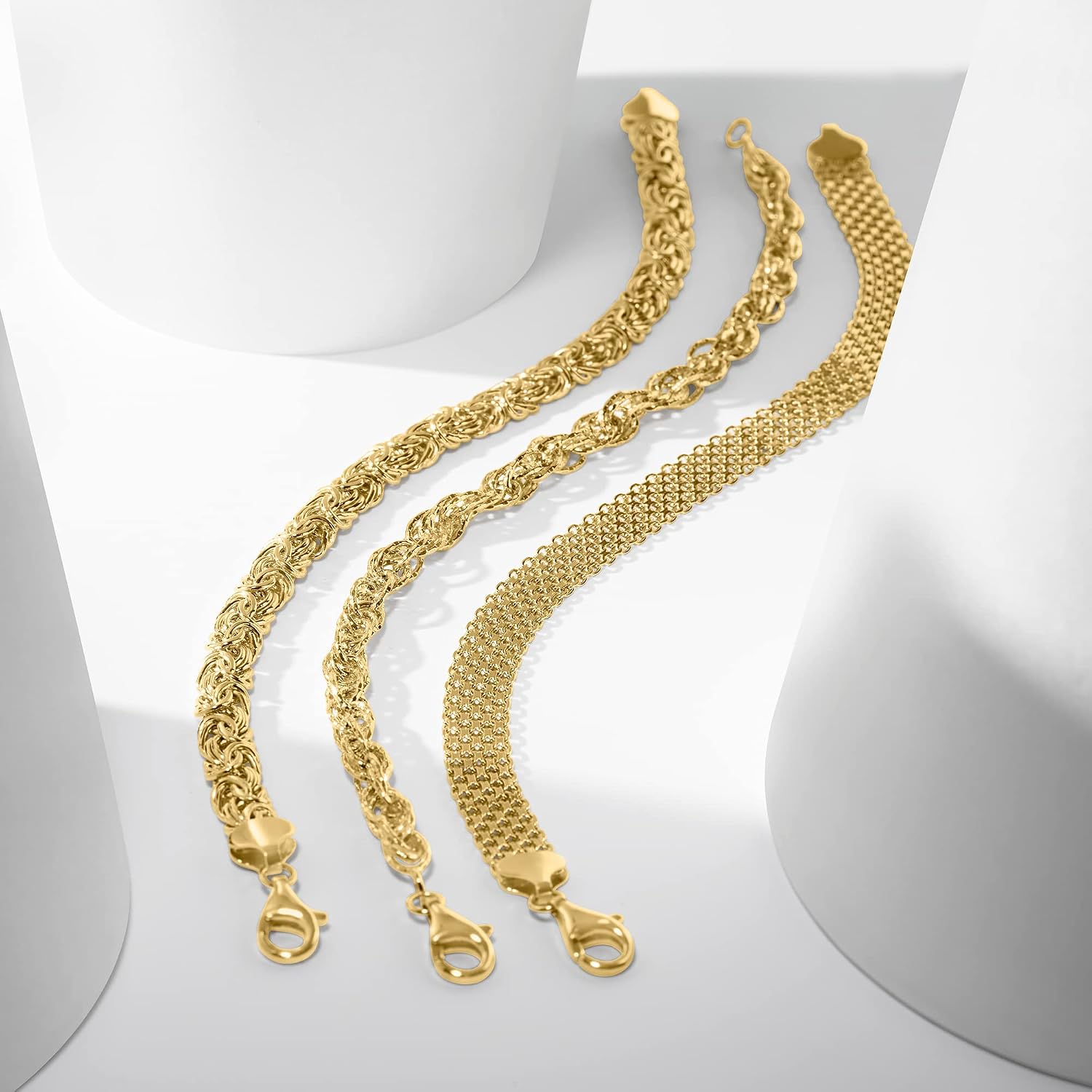 Three sterling silver link bracelets stacked together, classic polished design — view 1